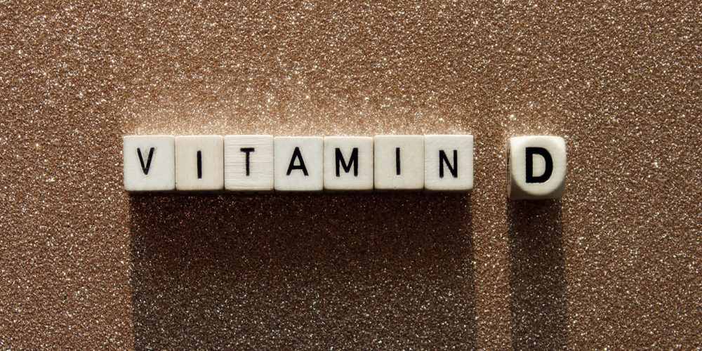 Vitamin-D Schriftzug Vitamin D mit Buchstaben auf Würfeln dargestellt